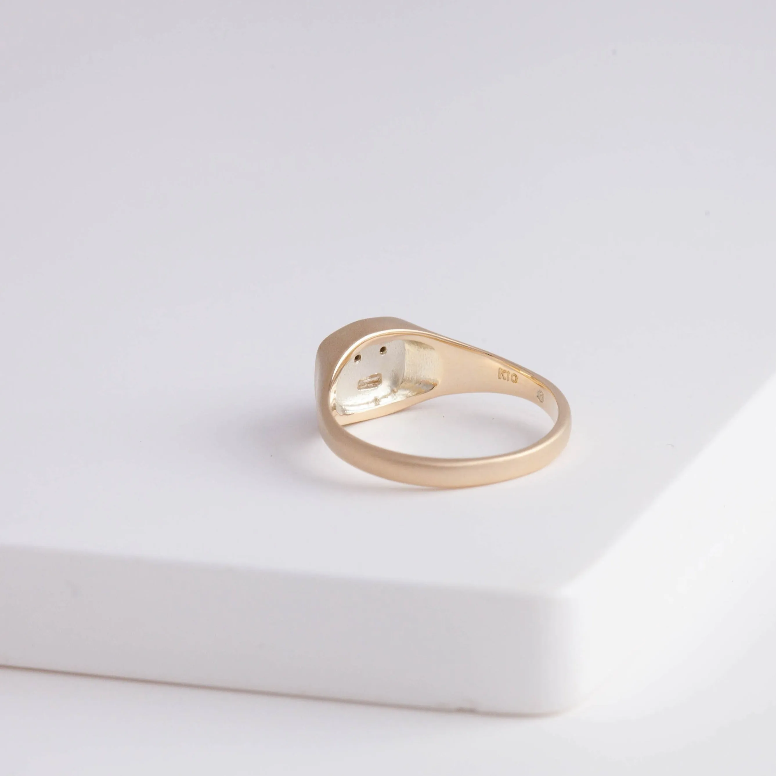 Small face signet ring with black and baguette diamond